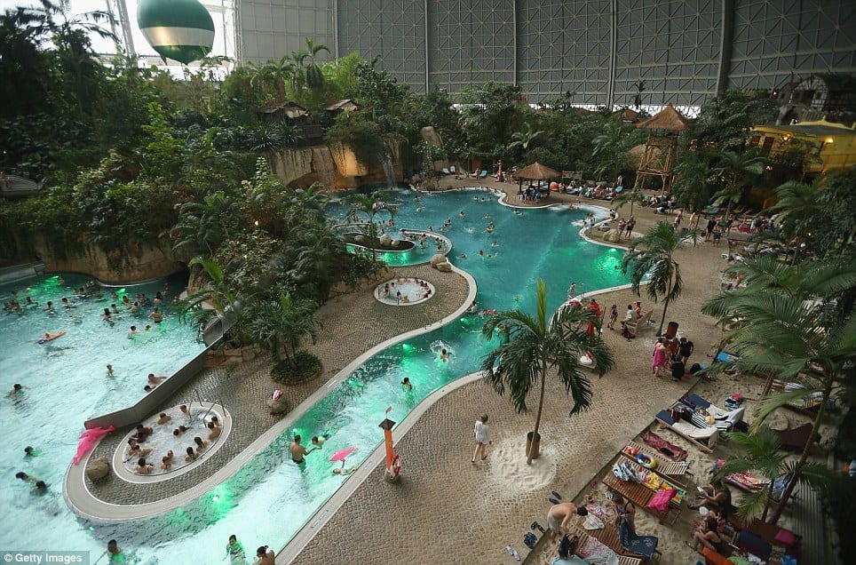 Relaxing: Tropical Islands is inside a hangar built originally to house airships designed to haul long-distance cargo. Visitors can be seen swimming in the lagoon at the resort